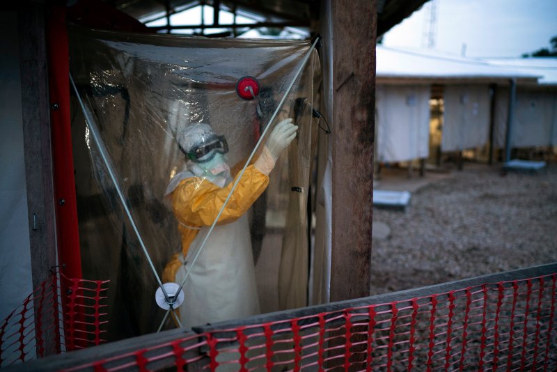 FILE - In this Saturday, July 13, 2019, file photo, a health worker wearing protective suit enters an isolation pod to treat a patient at a treatment center in Beni, Congo DRC. The World Health Organization and other partners said Tuesday Jan. 12, 2021, they are creating a global emergency stockpile of about 500,000 vaccines of Ebola vaccine to help stamp out any future outbreaks of the disease.(AP Photo/Jerome Delay, File)